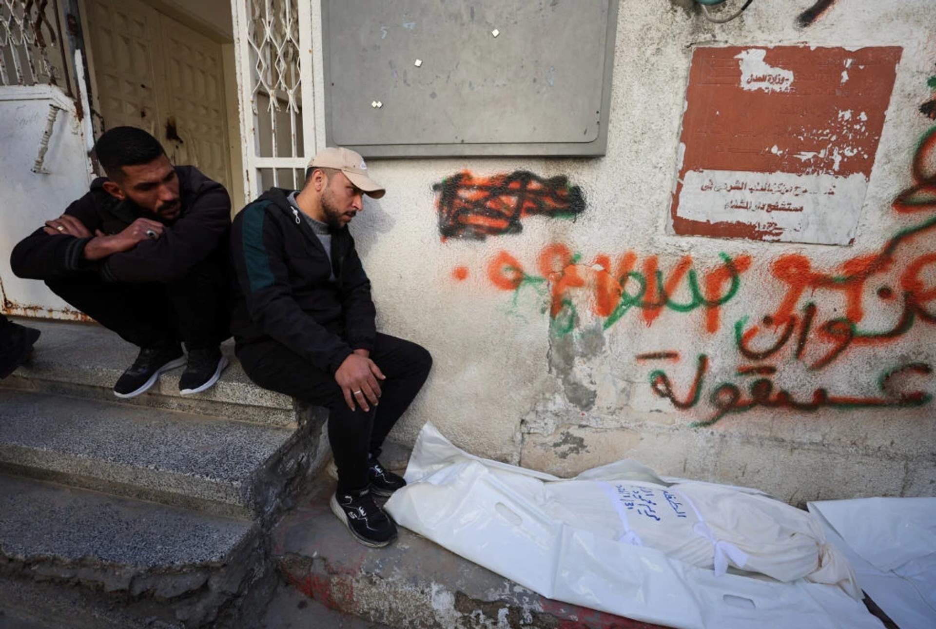 Mourners carry shrouded bodies wrapped in Palestinian flags during a funeral procession in Gaza following Israeli airstrikes