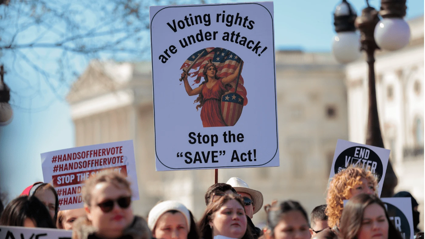 Protesters holding signs reading 'Protect Voting Rights' outside the Capitol