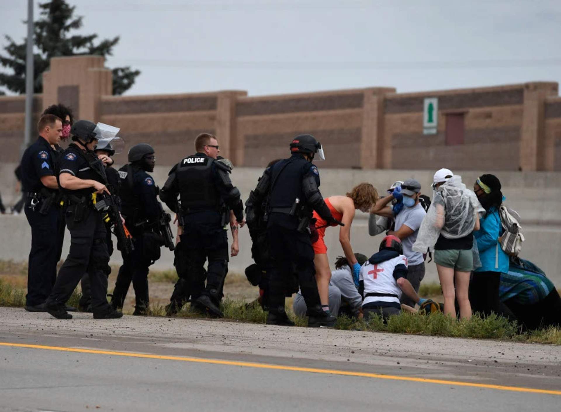 Street medics and police rush toward shot protester. [Radical Edward - Untelevised Media]