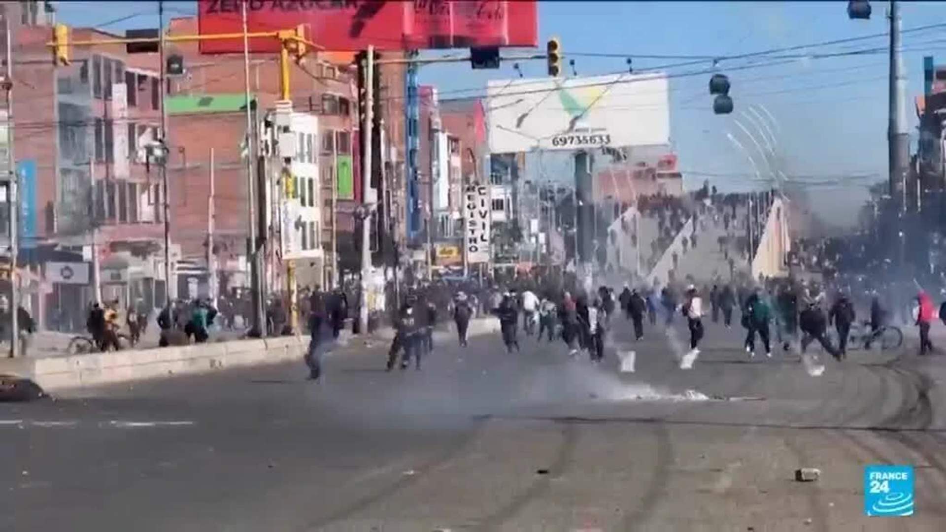 Bolivian police in riot gear clash with protesters blocking roads during the general strike