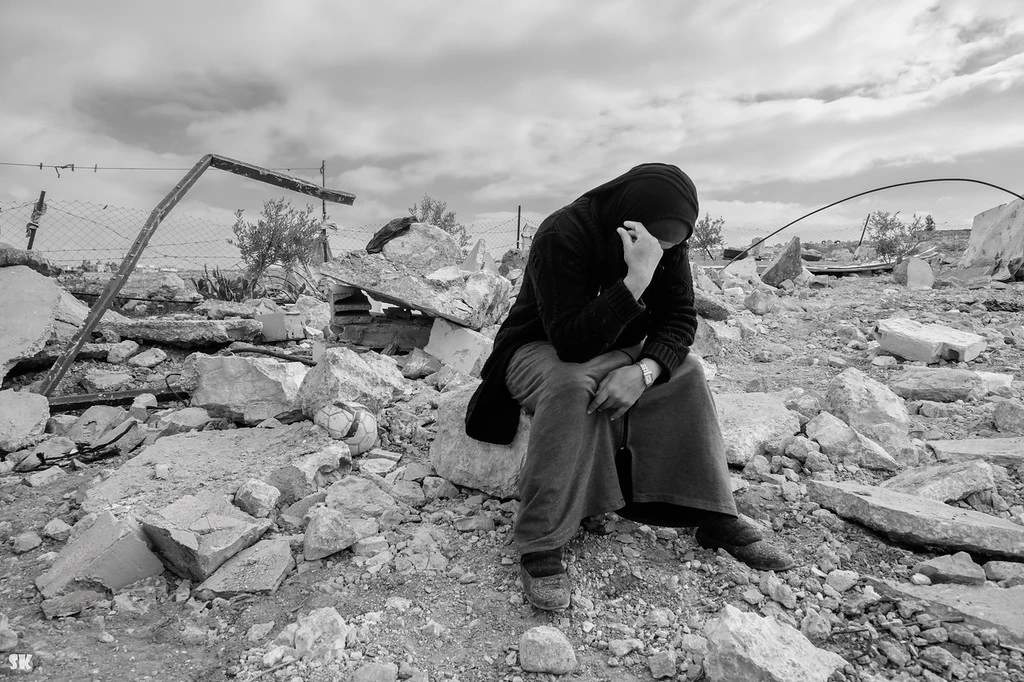 Palestinian woman amid ruins of demolished home in Masafer Yatta