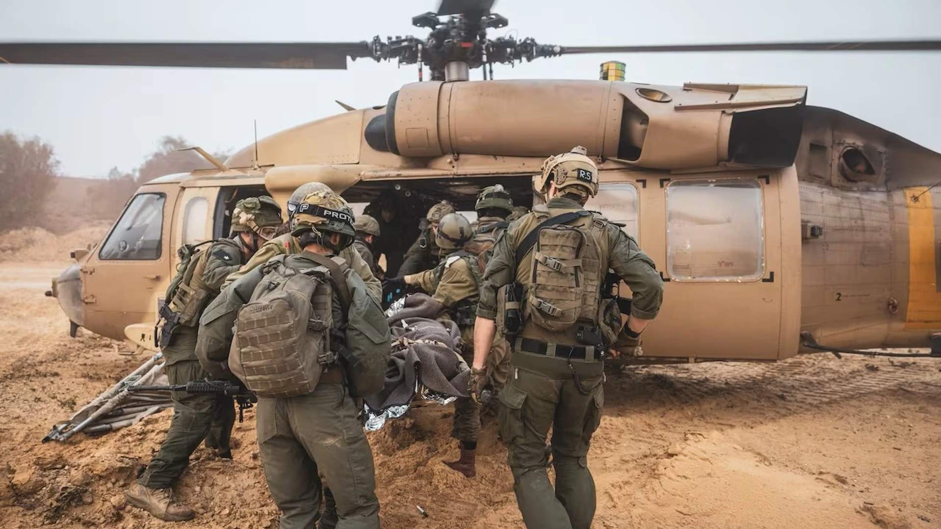 Israeli soldiers evacuate a wounded colleague into a military helicopter just outside of the Gaza border - Nov 26th [Israeli Defence Forces]