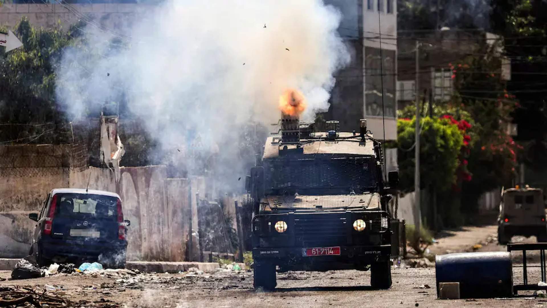 An Israeli armoured vehicle fires tear gas during an ongoing military operation in Jenin [Jenin occupied West Bank, July 4, 2023]