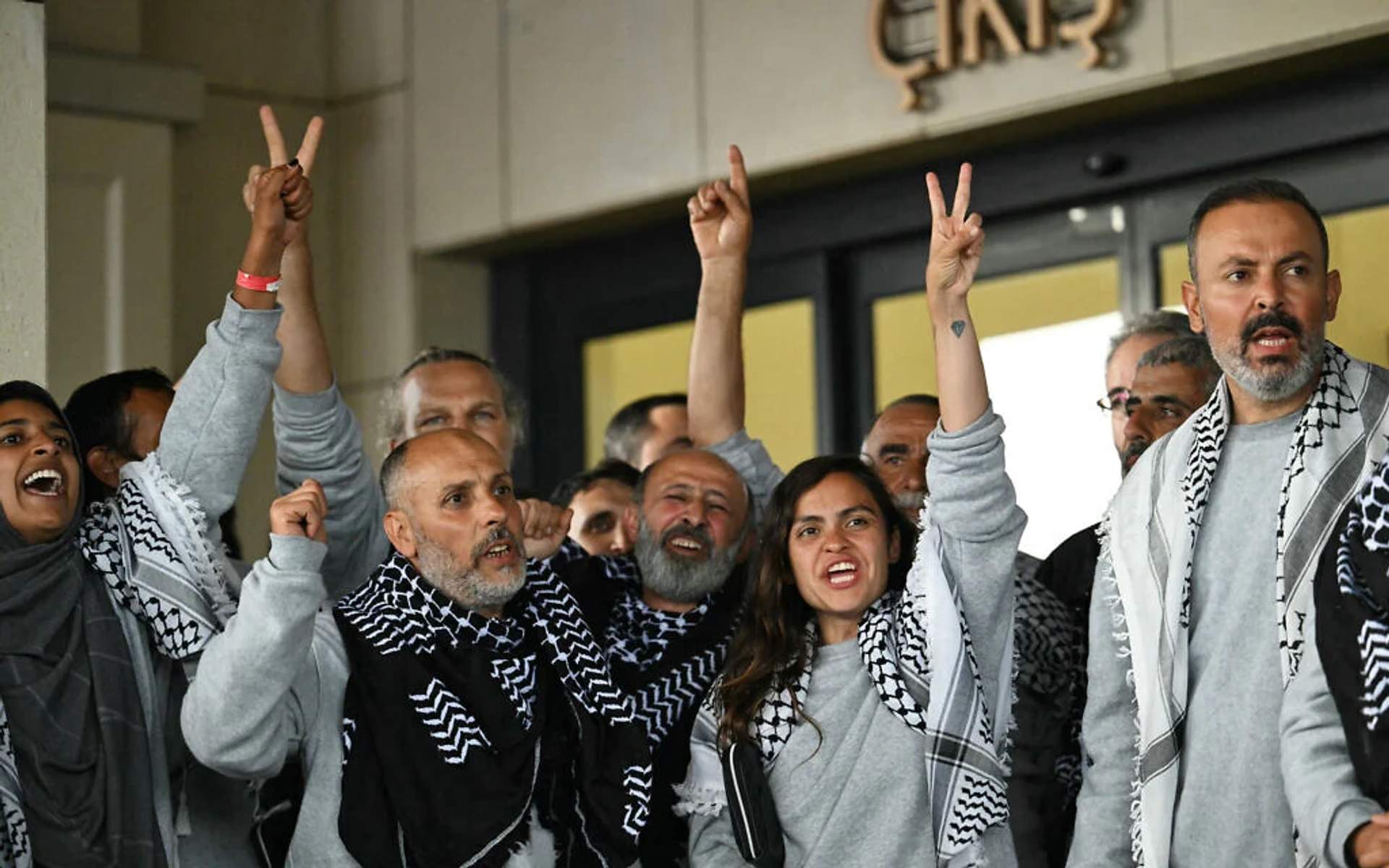 Freed Global Sumud Flotilla activists receiving medical assistance at Istanbul Airport after release from Israeli detention. One person lies on a stretcher.