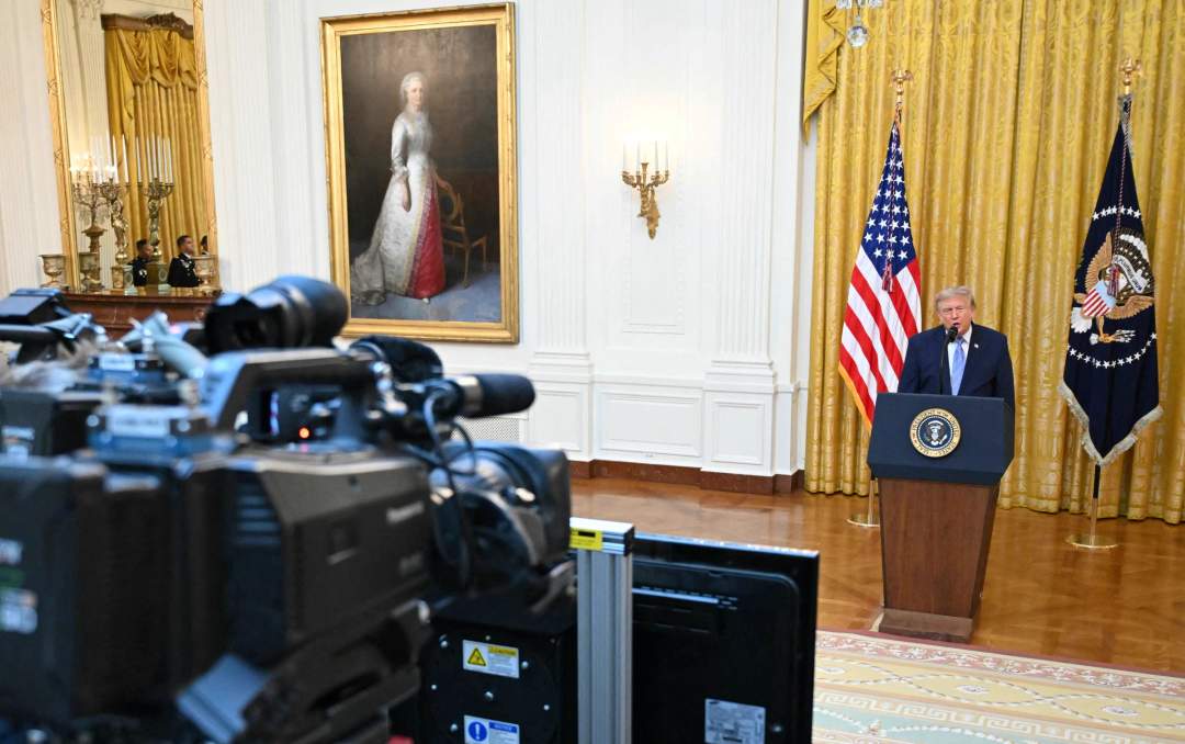 Trump speaking at podium in the East Room of the White House during election security address