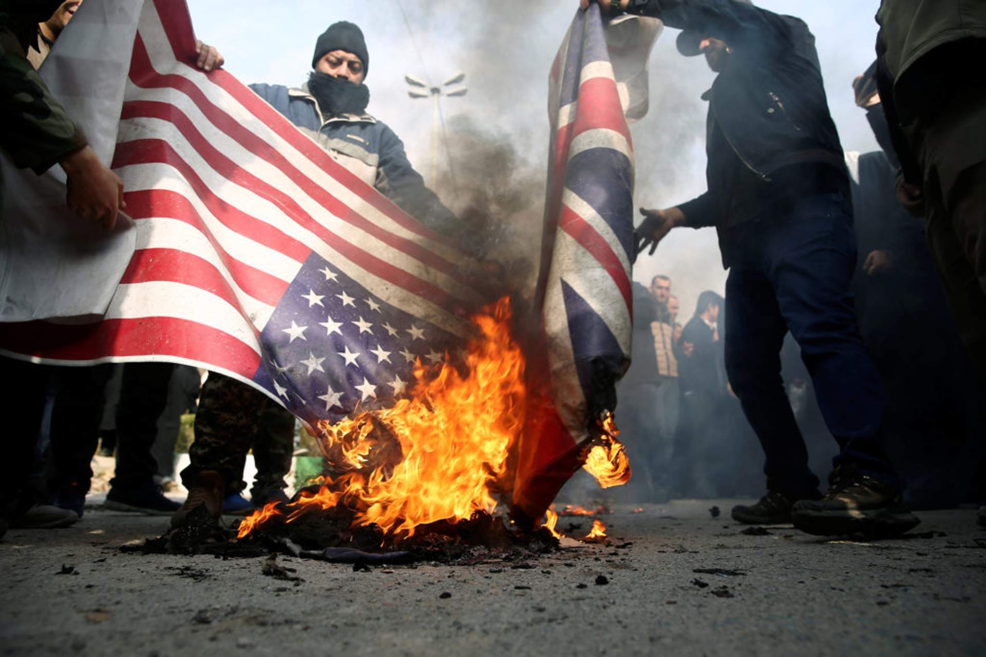 Demonstrators burn the U.S. and British flags during a protest against the assassination of the Iranian Major-General Qassem Soleimani in Tehran Jan. 3, 2020