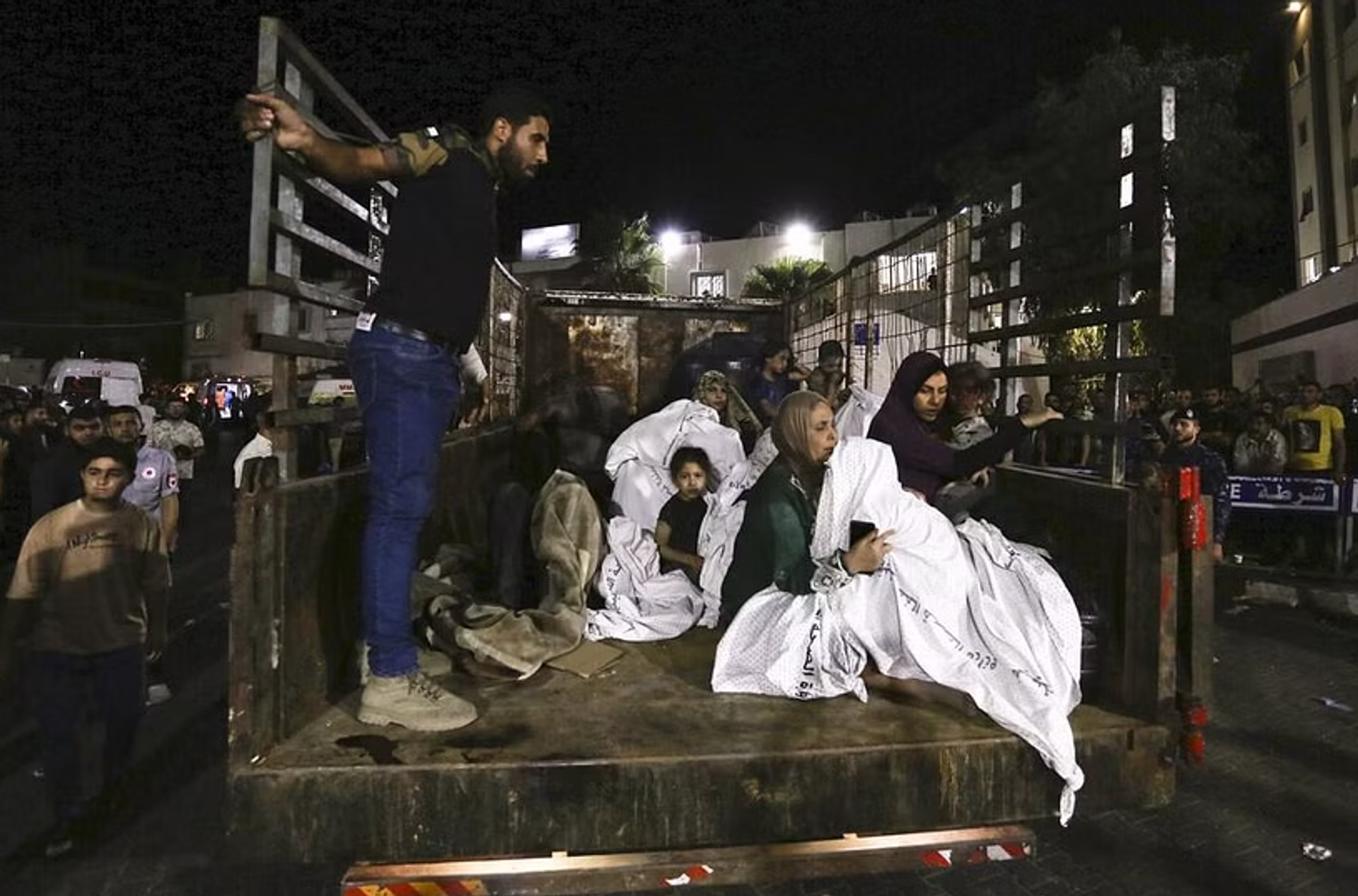 Injured people are transported in the back of a truck to local hospital in Gaza