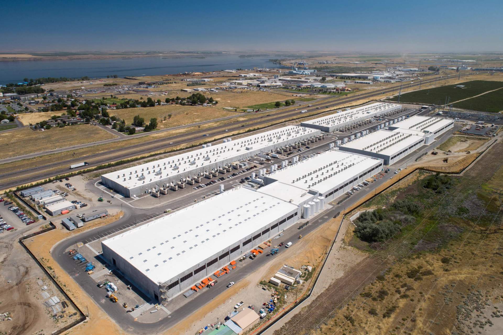Aerial view of Amazon data center construction near Boardman, Oregon in February 2026 showing massive warehouse buildings and surrounding farmland.