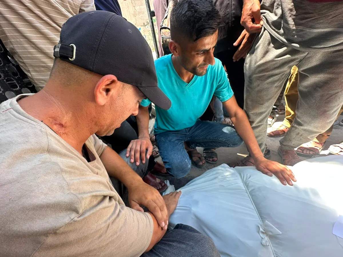 Rescue workers and civilians amid rubble following Israeli airstrike on Jabalia police station