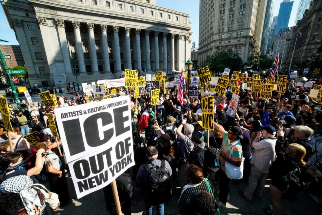 Crowd of protesters with signs and banners demonstrating against ICE in New York City