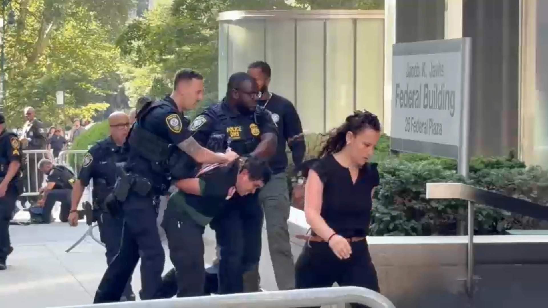 Suspect being taken into custody after the incident.
