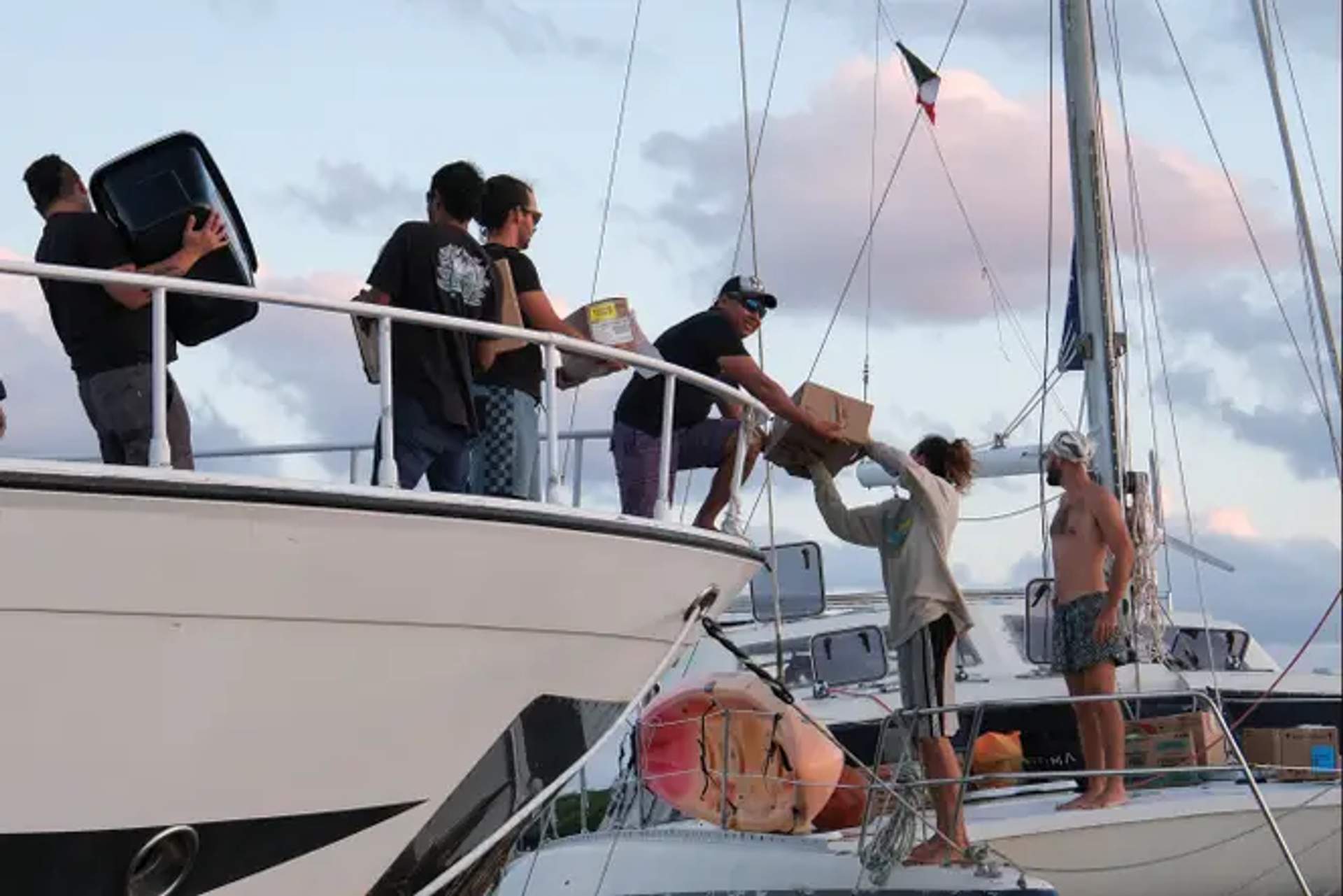 Activists load humanitarian aid onto a boat during the Nuestra América solidarity convoy to Cuba
