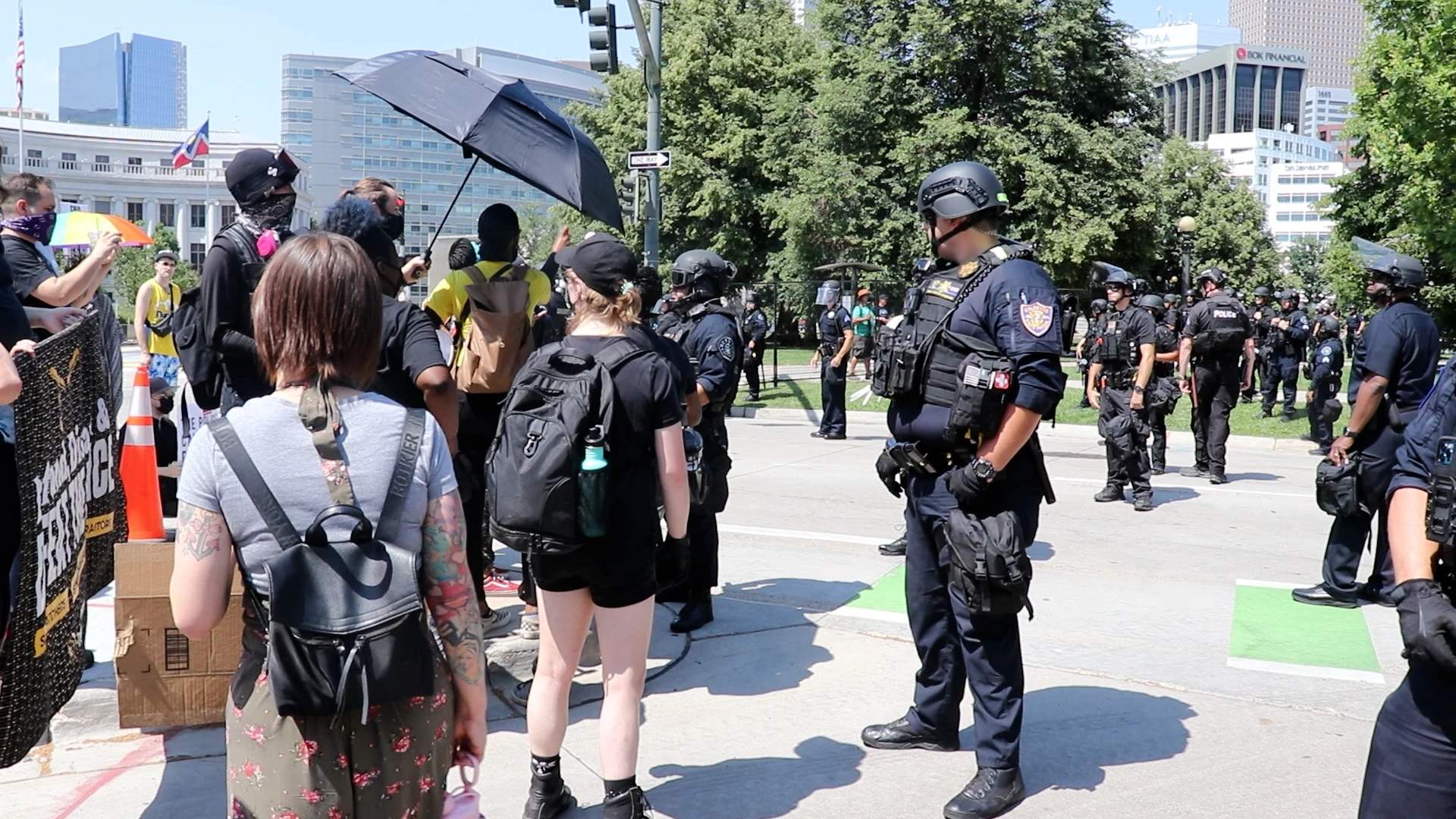 Protesters taunting and distracting pigs while attendees leave the pig party.