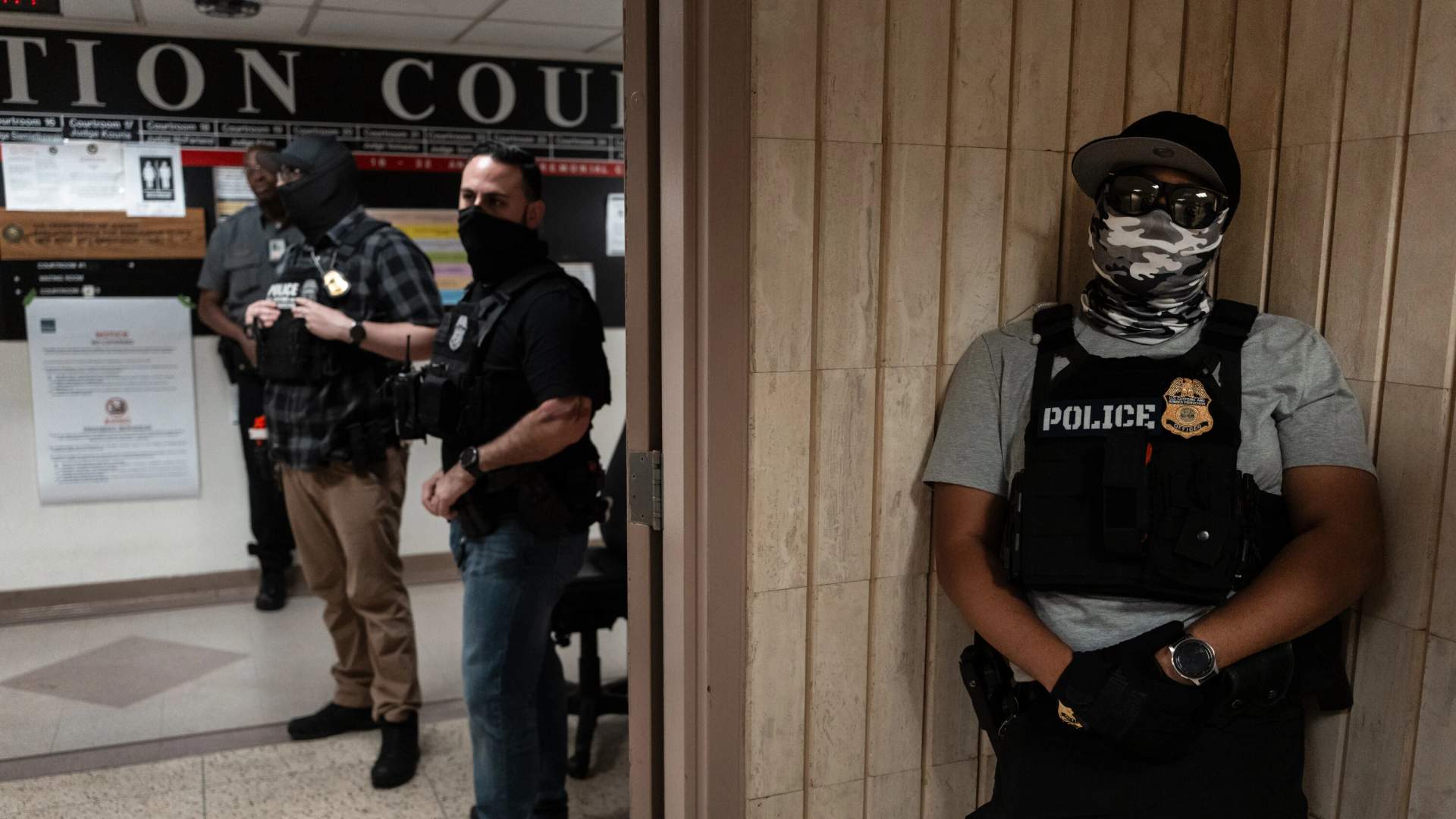 Masked ICE agents outside NYC immigration court.
