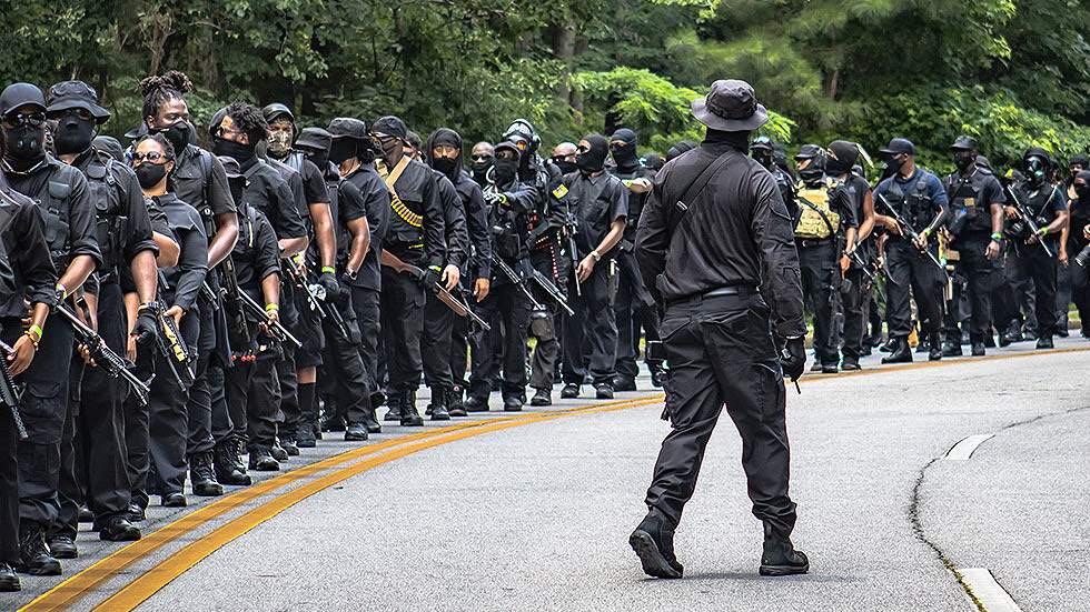 Members of the NFAC march in formation along highway