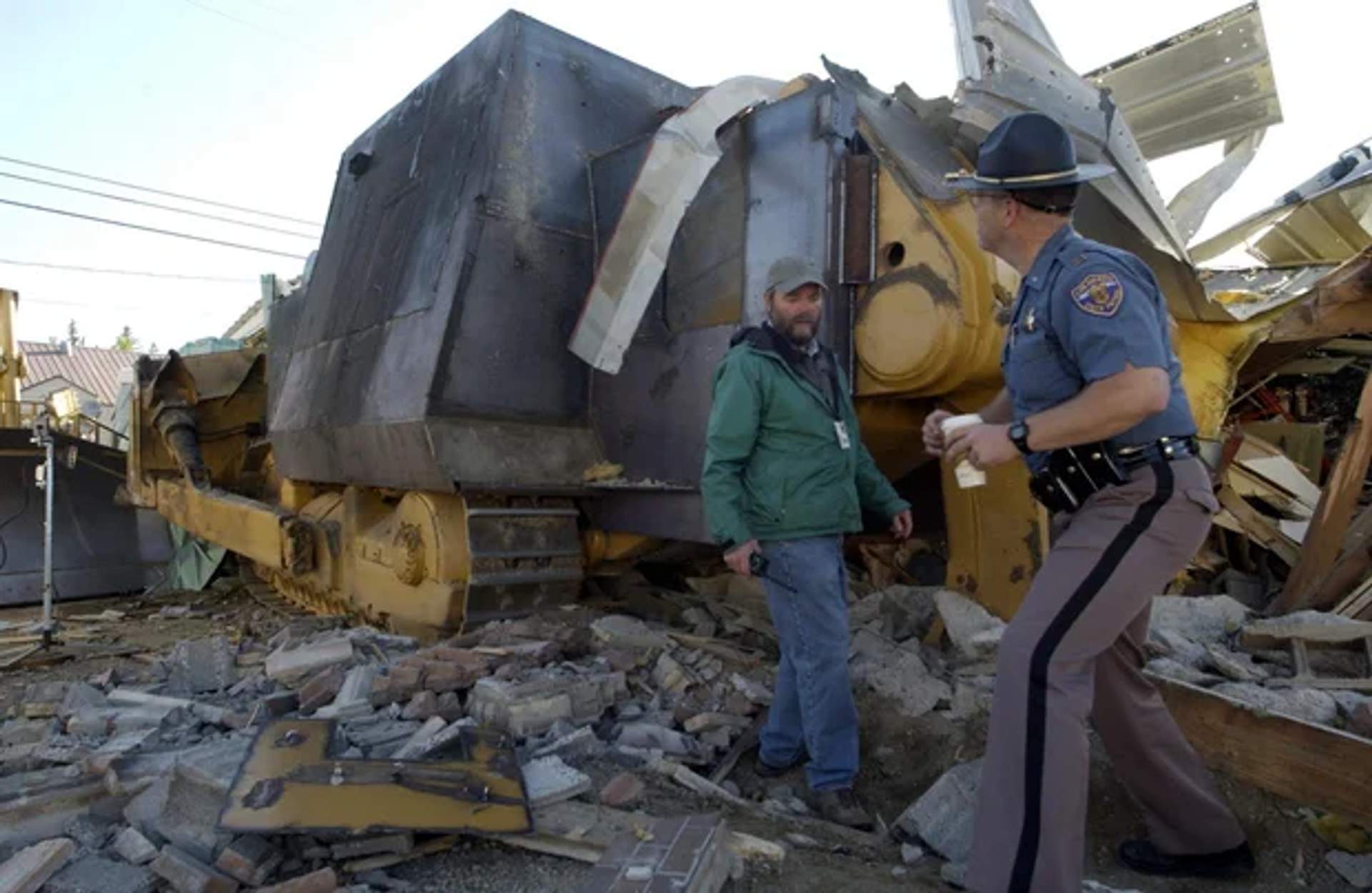 Colorado State Patrol Captain Gary Torgerson and Grand County Emergency Manager James Holahan examine the armored bulldozer in Granby Colorado June 5 2004