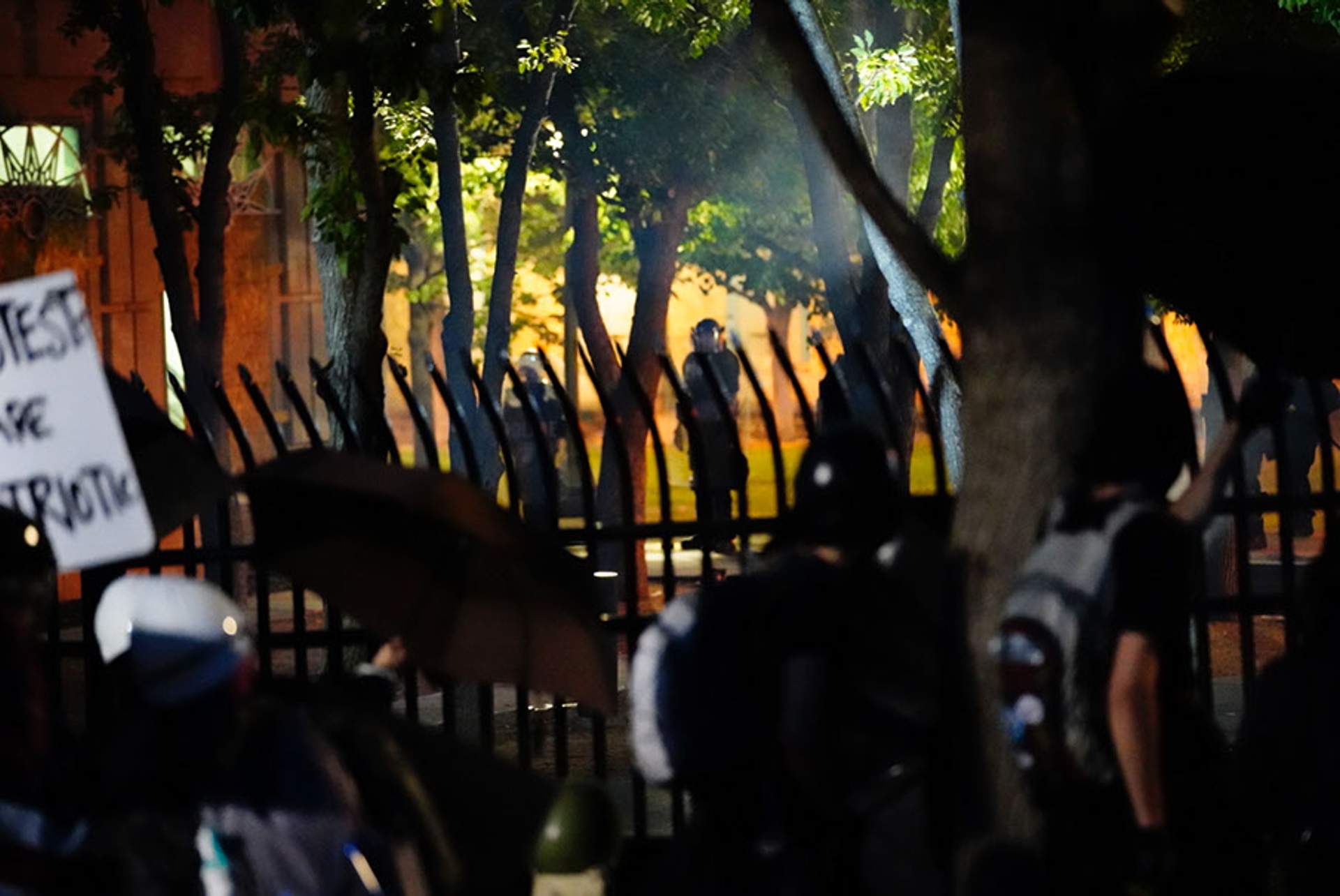 Protesters square off against Aurora riot police before de-erecting the fence.