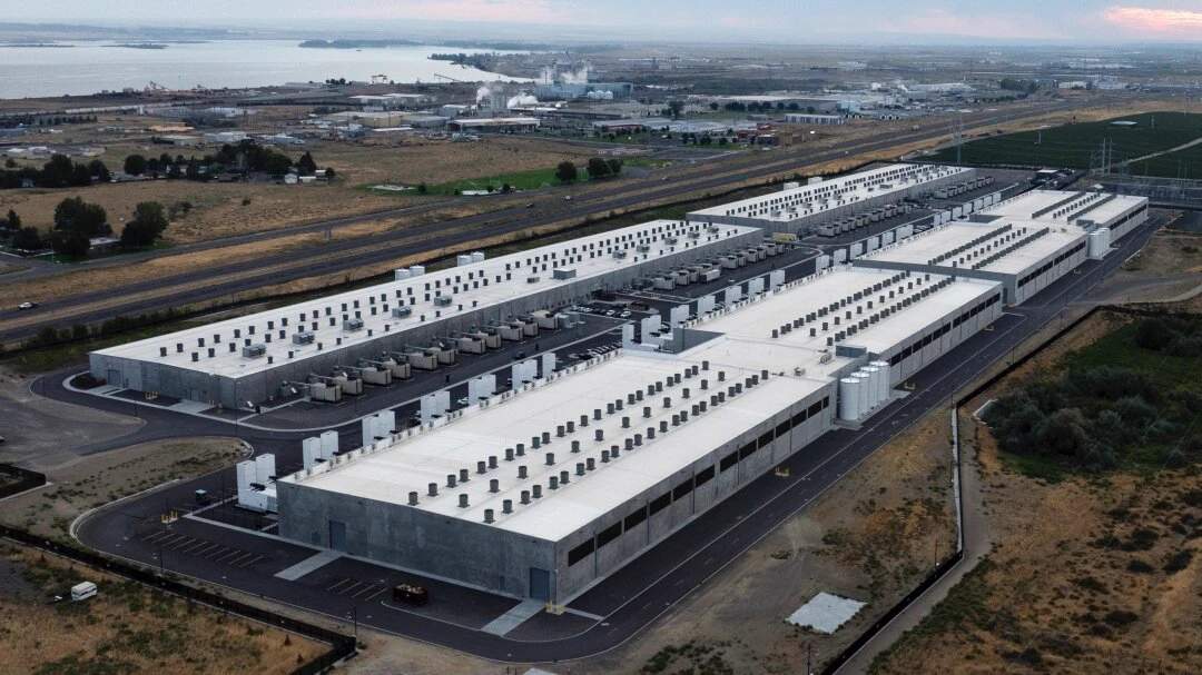 An Amazon Web Services data center facility in Boardman, Oregon, showing large industrial buildings in the rural landscape of Morrow County.