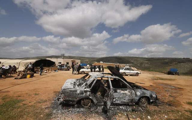 Aftermath of an Israeli settler attack on a Palestinian village in the West Bank, showing destroyed buildings and debris