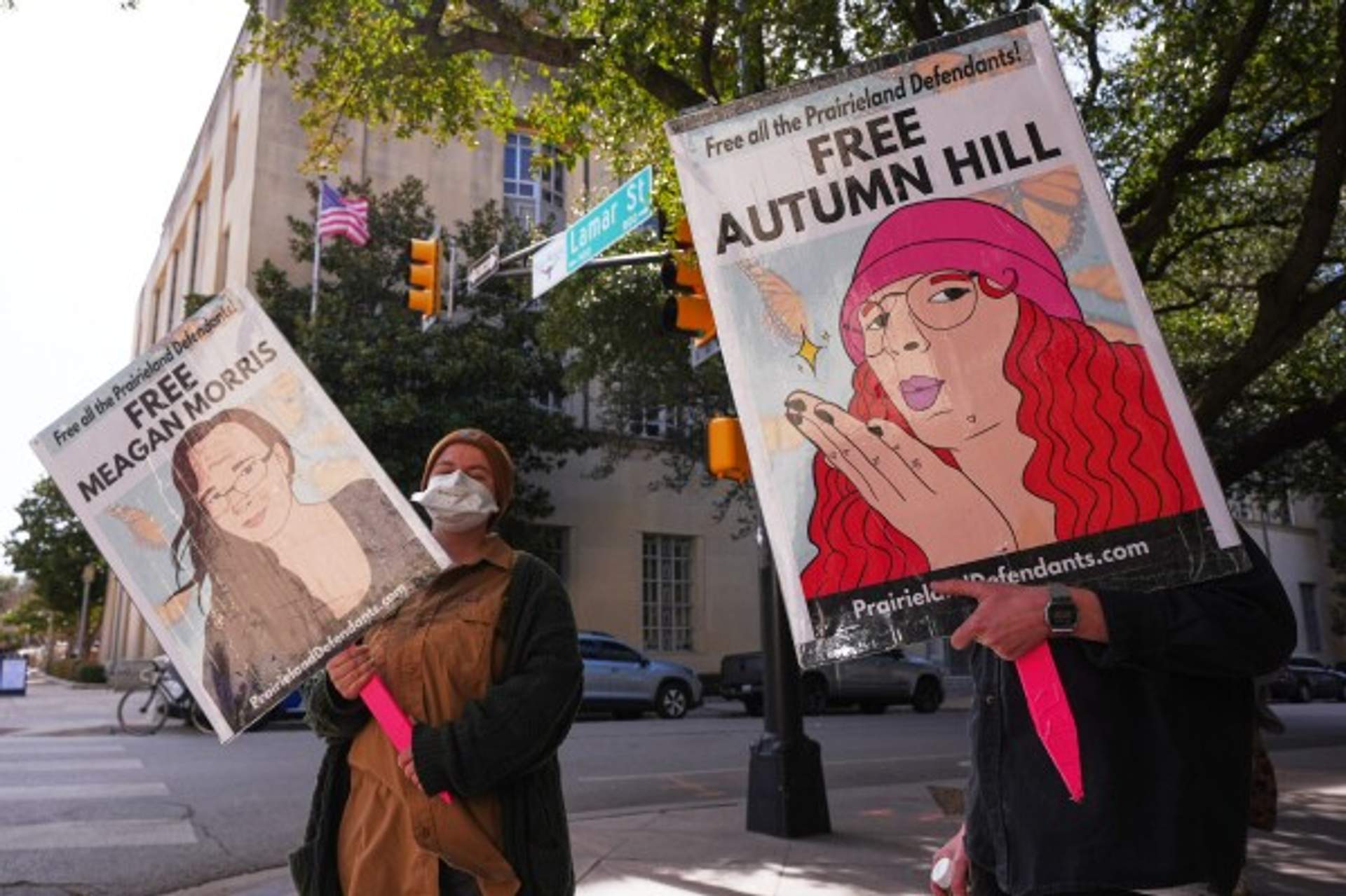 Protesters hold signs for the Prairieland 8 outside the Courthouse
