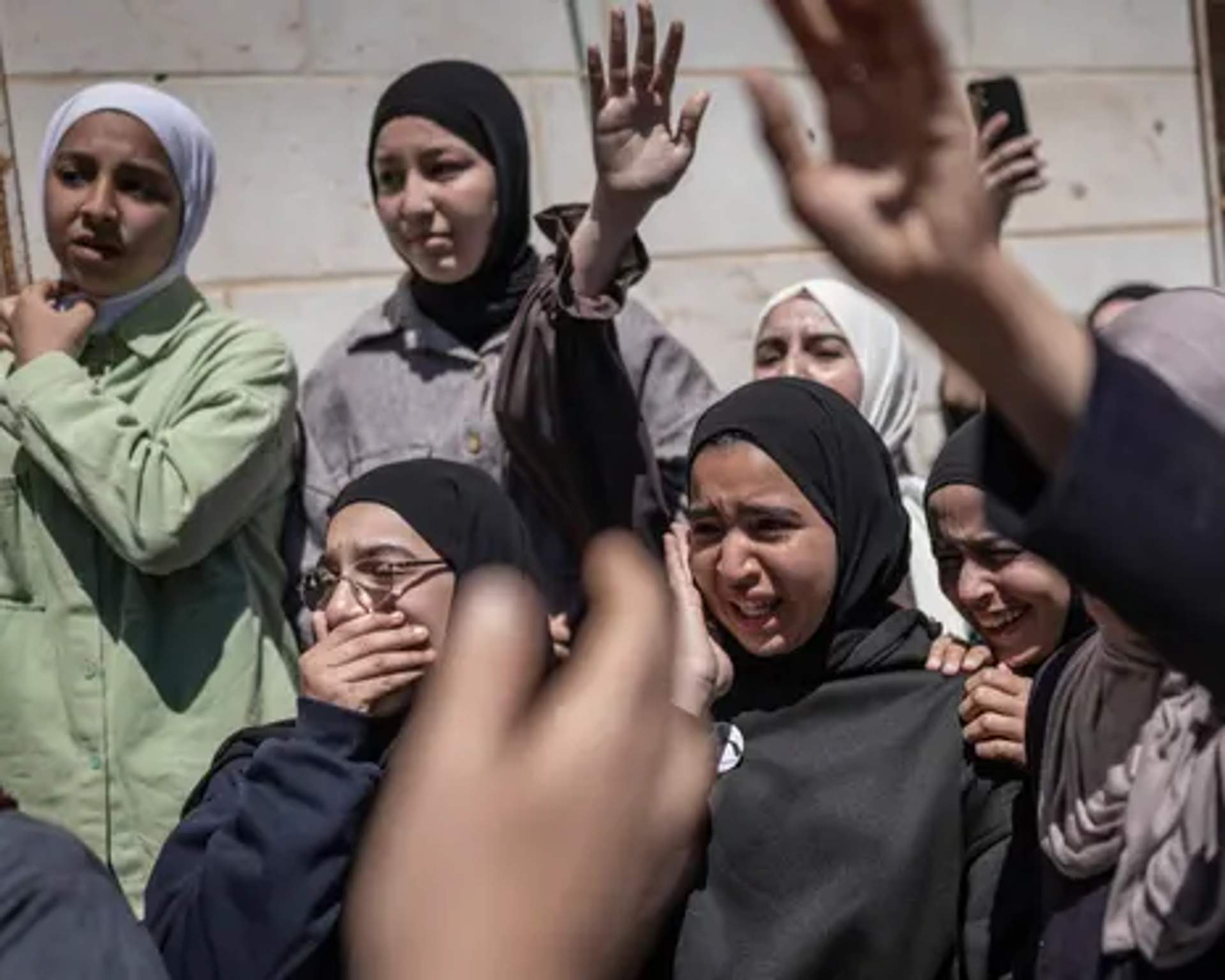 Family and friends mourn the death of Aws al-Naasan, 14, during his funeral in al-Mughayyir, north-east of Ramallah, on April 22, 2026