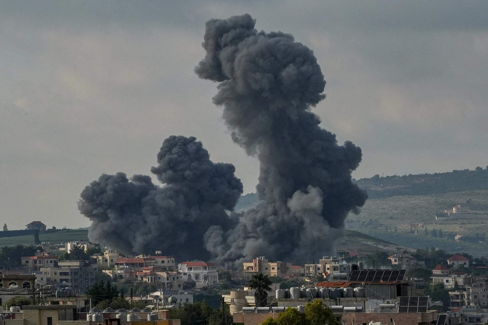 Large plumes of dark smoke rising over buildings in Gaza after Israeli airstrike, May 2026