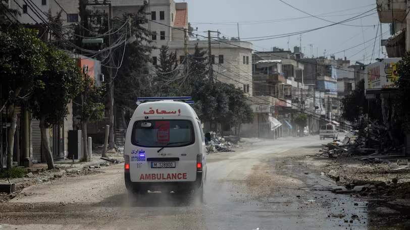 An ambulance crew responds after housing was destroyed by an Israeli air strike in Nabatieh, southern Lebanon.
