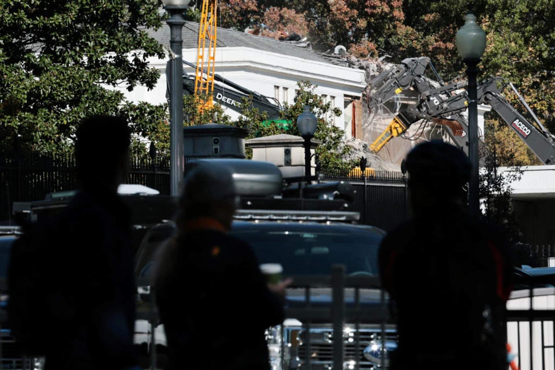 Construction equipment and scaffolding surround the partially demolished East Wing of the White House with exposed structural beams and debris