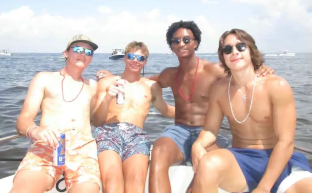 Nolan Wells poses with friends on a boat headed to Horn Island on July 4, 2026