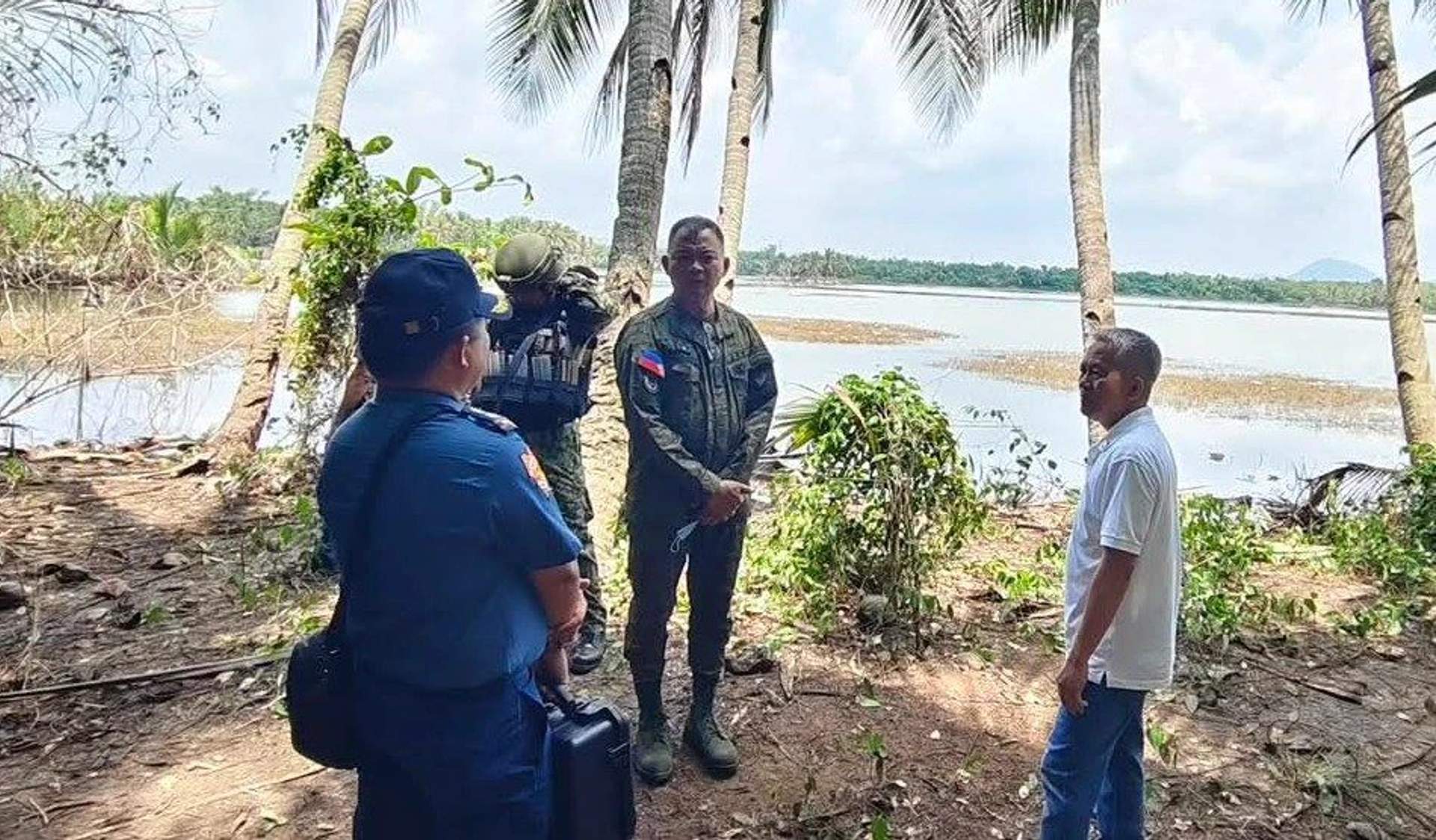 Brig. Gen. Ted Dumosmog, commander of the 303rd Infantry Brigade, and Toboso Mayor Richard Jaojoco inspect the scene of the slaughter in northern Negros, where 19 were massacred by the military.