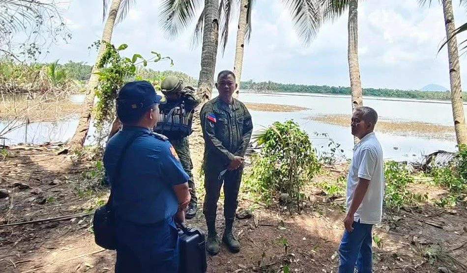 Brig. Gen. Ted Dumosmog, commander of the 303rd Infantry Brigade, and Toboso Mayor Richard Jaojoco inspect the scene of the slaughter in northern Negros, where 19 were massacred by the military.