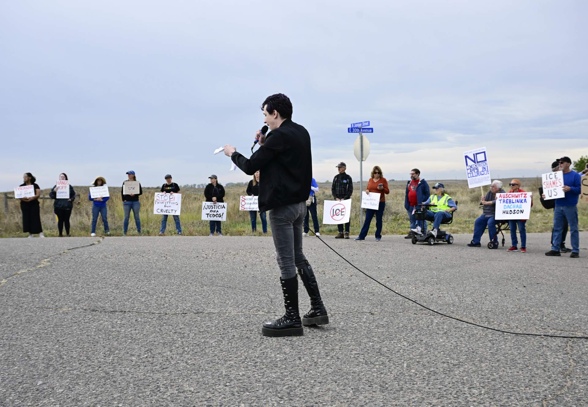 Protest speaker with megaphone at rally against ICE detention center in Hudson, Colorado