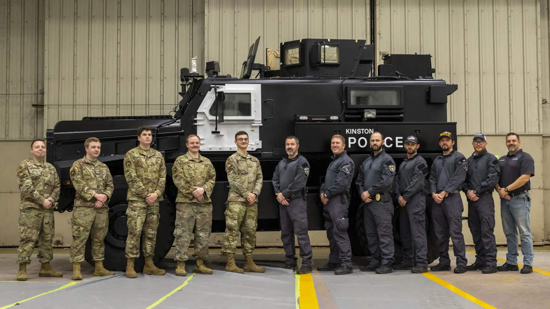 Kinston, NC (pop.19,900) police officers and Army unit stand infront of 1033 gifted MRAP