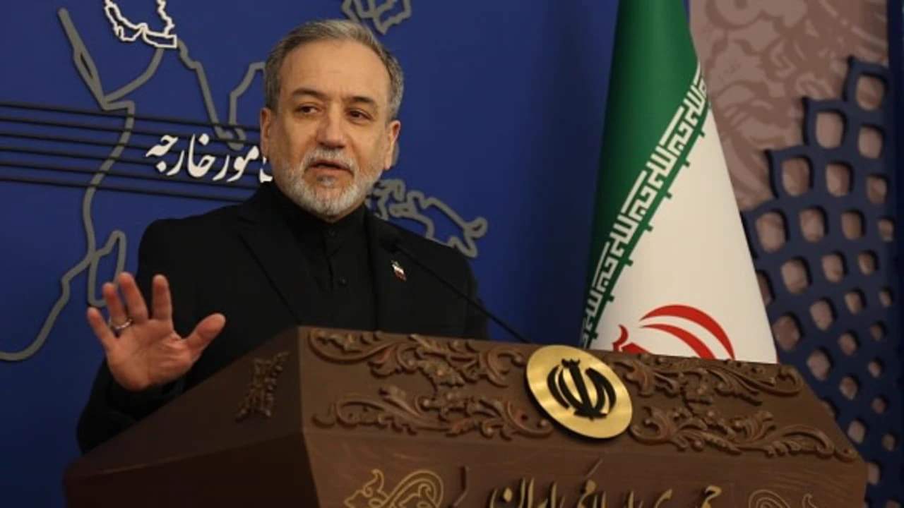 Iranian Foreign Minister Seyed Abbas Araghchi speaking at a podium during a press conference