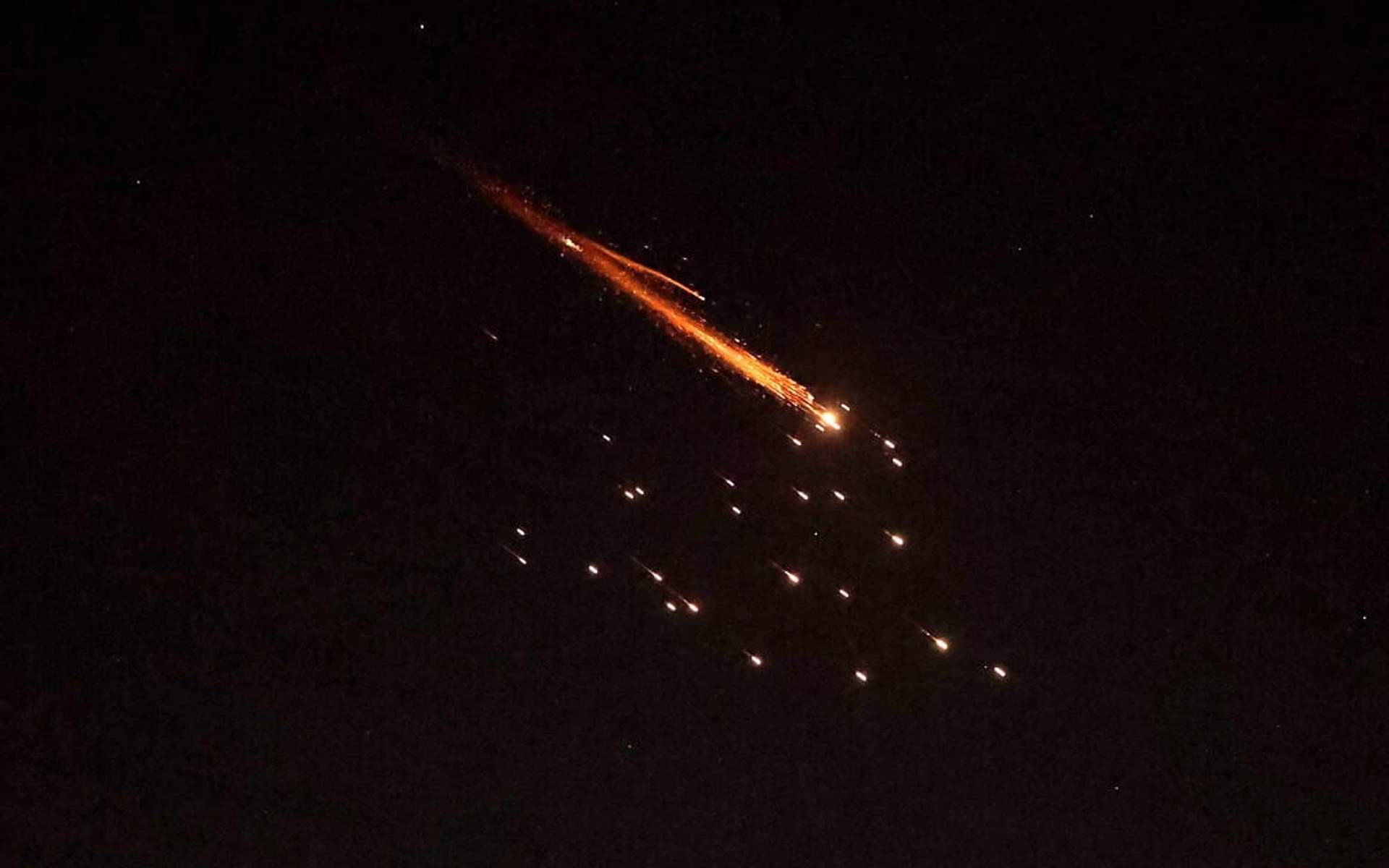 Iranian ballistic missiles streak across the night sky above the Israeli coastal city of Netanya during a retaliatory strike