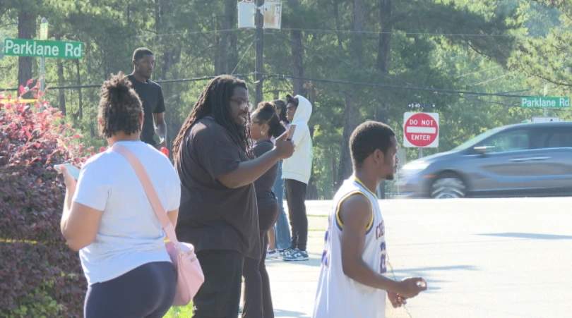 A crowd of demonstrators holding signs and gathering at a protest rally in Columbia, South Carolina after Rick Chow was acquitted in the shooting death of Cyrus Carmack-Belton