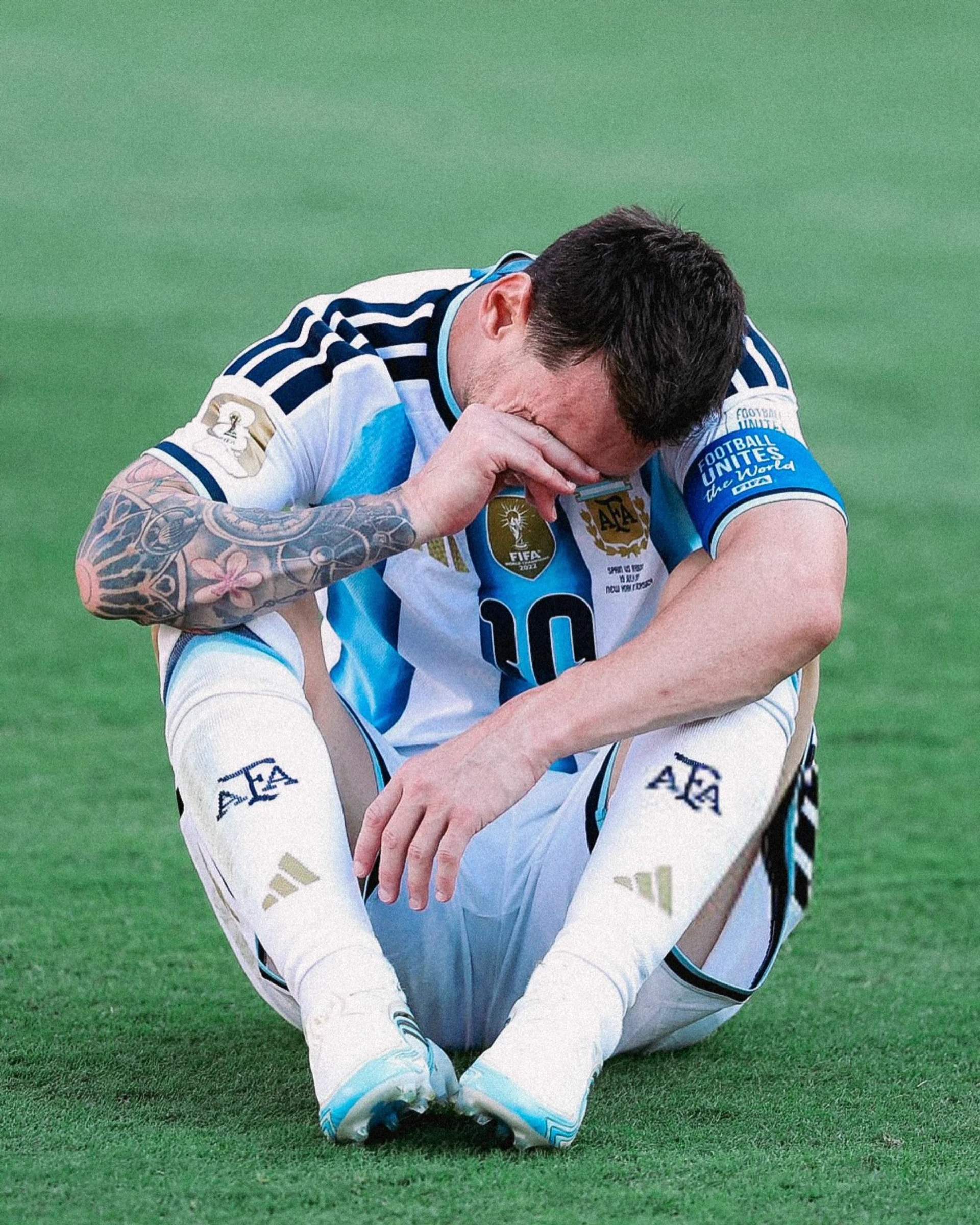 Lionel Messi of Argentina sits alone on the pitch after his team lost the 2026 FIFA World Cup Final to Spain 1-0 in extra time