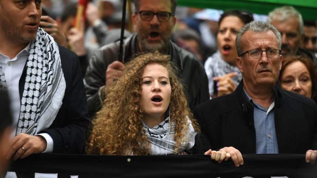 Palestinian activist Ahed Tamimi marches through central London in 2019 (Photo by Daniel LEAL