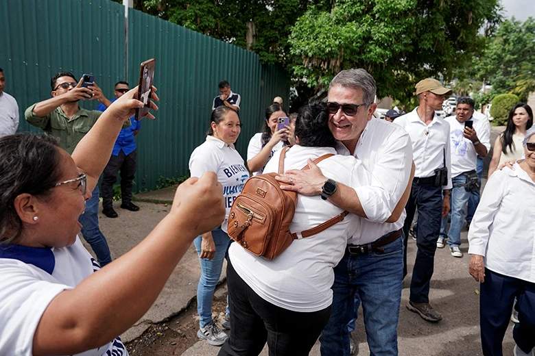 Juan Orlando Hernandez greeted by supporters at airport in Honduras after Trump pardon