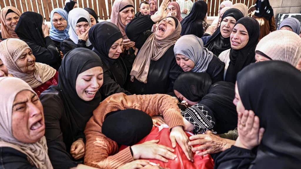 Palestinians mourned the deaths of Aws Hamdi al-Naasan, 14, and Jihad Marzouq Abu Naim, 32, who they said were killed in a settler attack on a school in the West Bank village of Al-Mughayi
