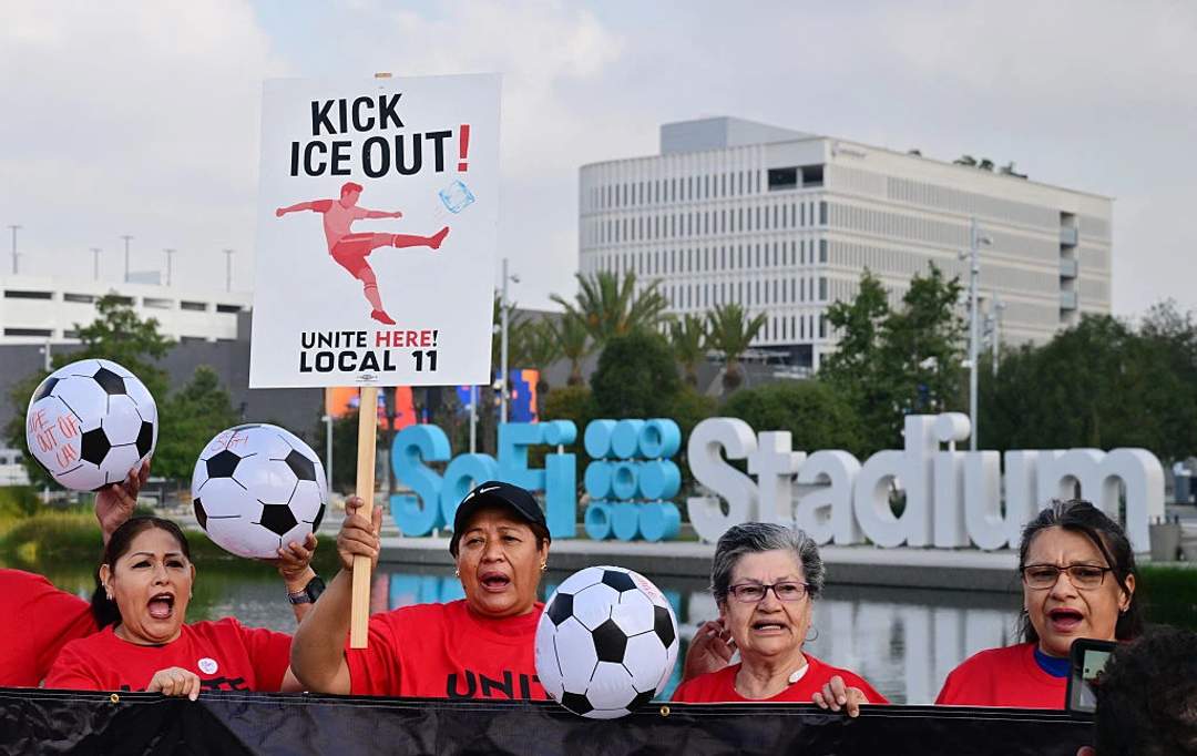 Stadium workers celebrating after authorizing a strike at SoFi Stadium in Los Angeles during World Cup preparations