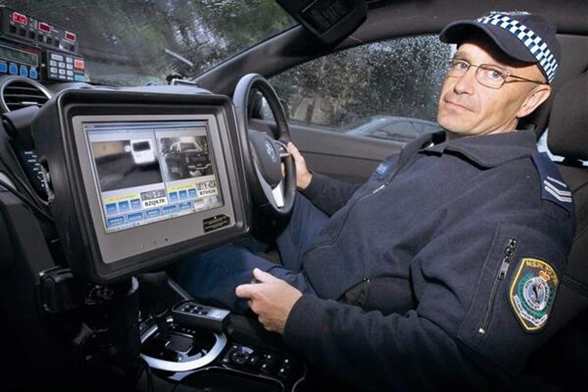 Wollongong highway patrol’s Senior Constable Phil Roddy demonstrates the automatic number plate recognition technology.
