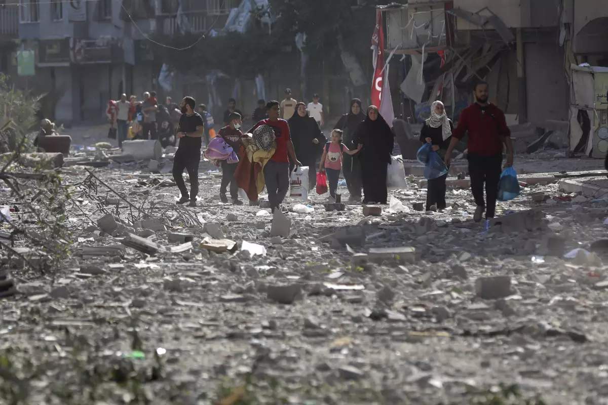 Palestinians leave their homes following Israeli bombardment on Gaza City, Monday, Oct. 30, 2023. AP Photo Abed Khaled