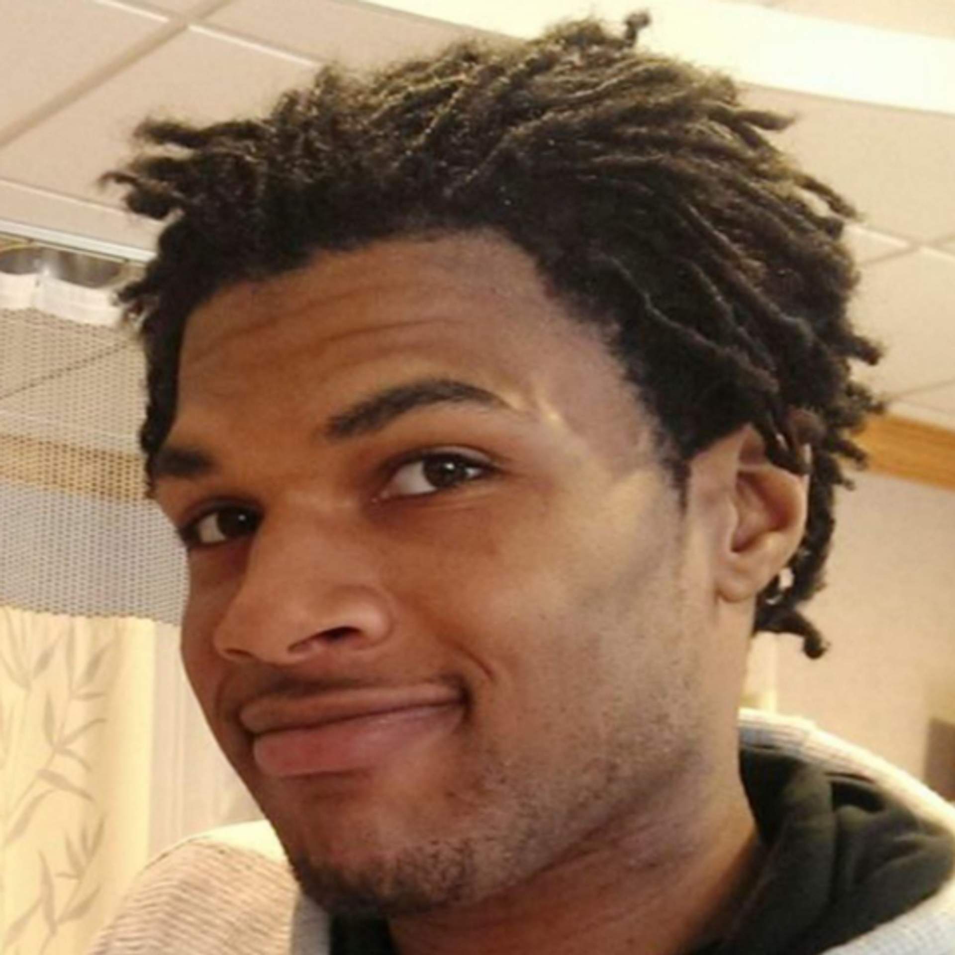 Portrait of John Crawford III, smiling.