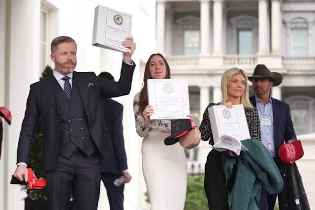 Pam Bondi stands with far-right influencers displaying binders of years old public Epstein files.