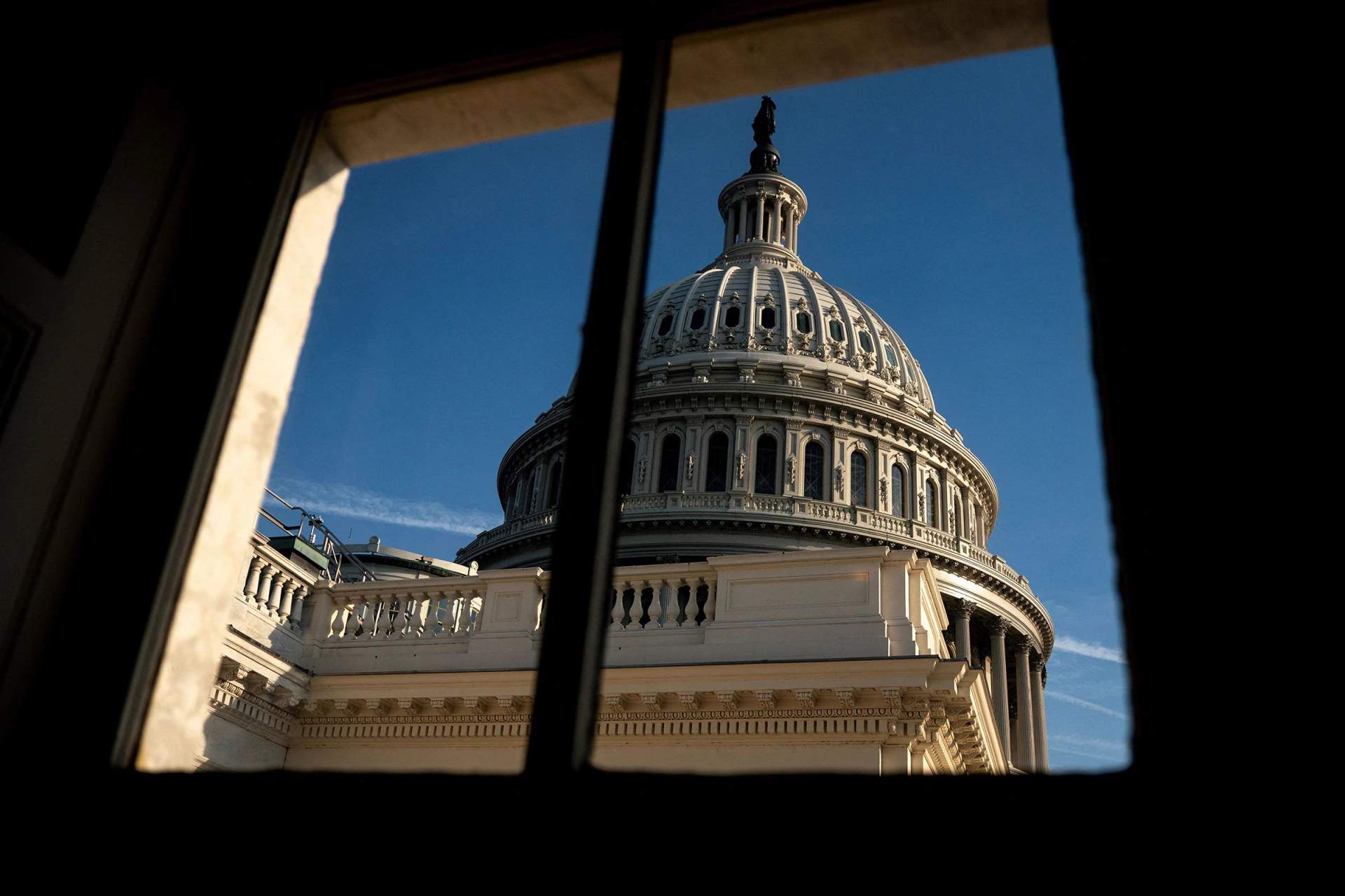 The U.S. Capitol building dome rising against a blue sky in Washington D.C., the seat of Congress where the Section 702 surveillance law extension was debated and voted on