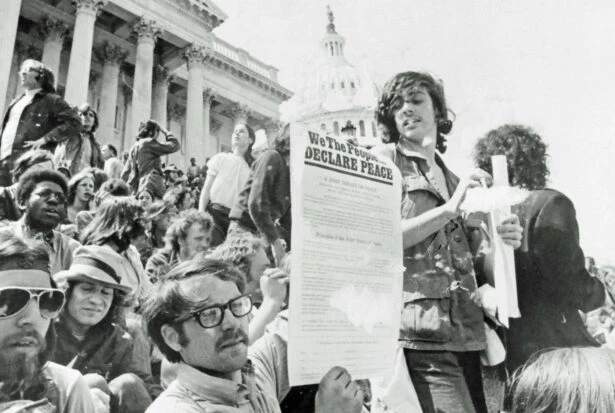 A demonstrator holds a copy of the Peopleโs Peace Treaty on the steps of the U.S. Capitol during Mayday protests May 5, 1971. (Flickr/Washington Area Spark)