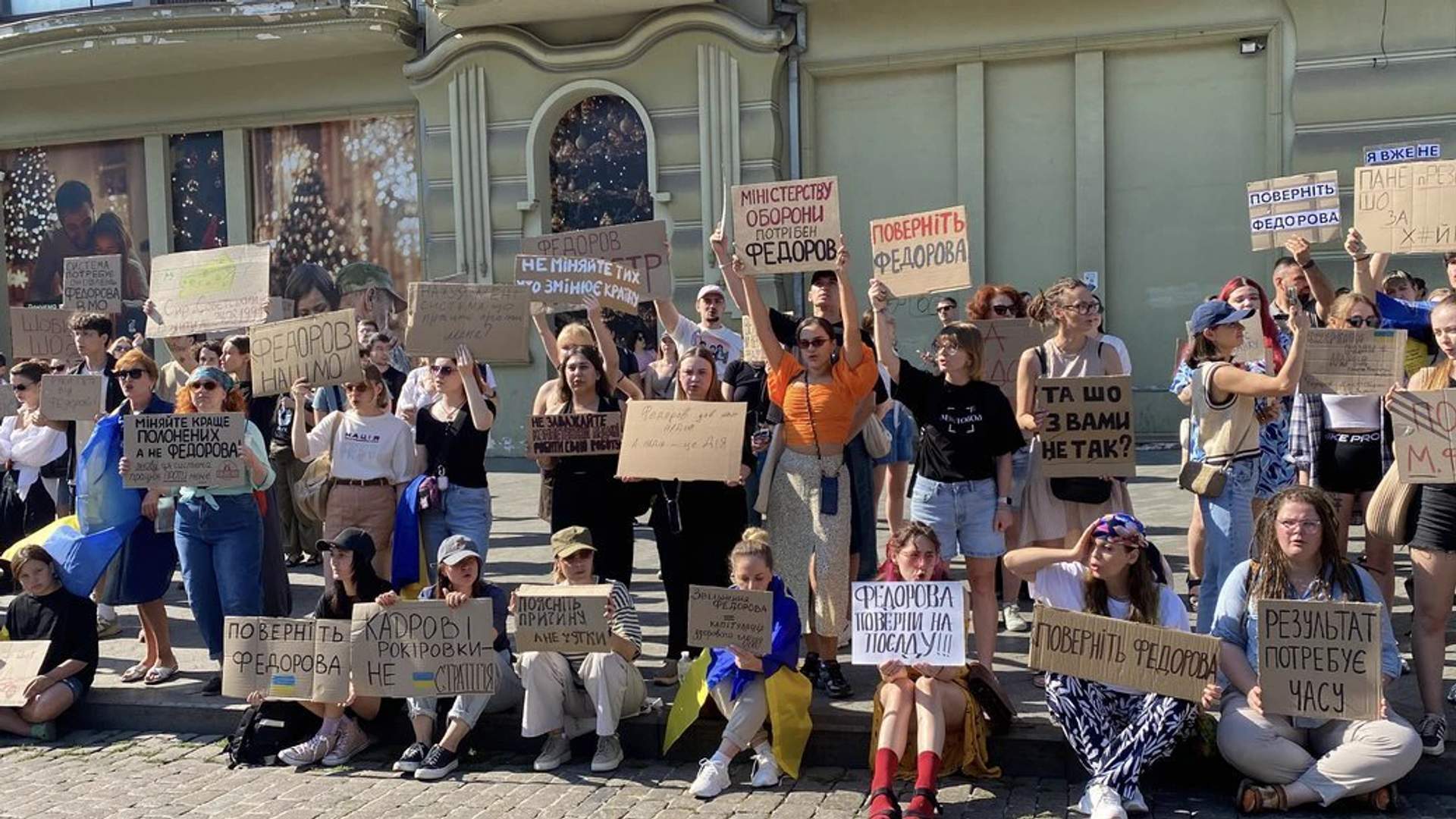 Protesters in Odesa holding signs and Ukrainian flags in support of Fedorov