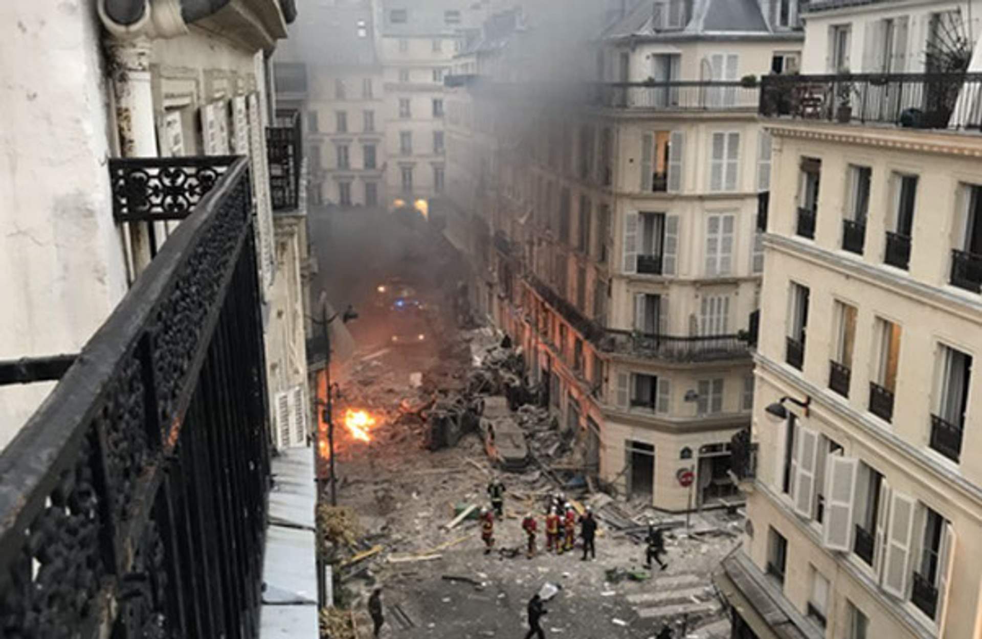Overturned and burned vehicles outside the Paris bakery following the explosion