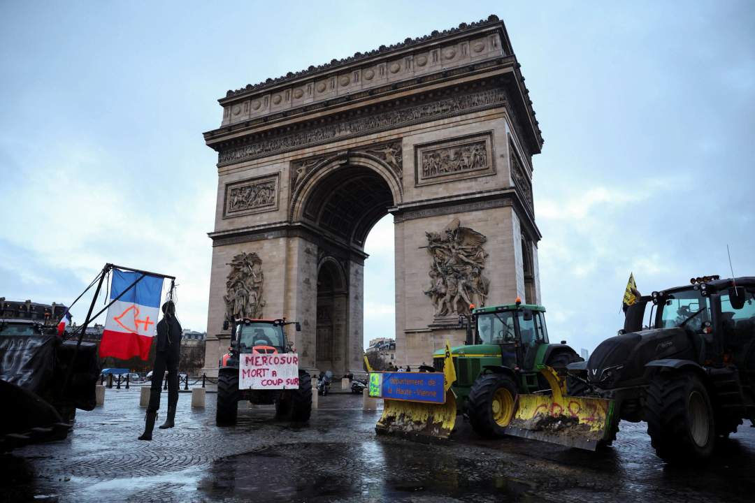 Rows of farm tractors parked along Avenue des Champs-Elysees with the Arc de Triomphe in the background during the French farmers protest in Paris, January 2026